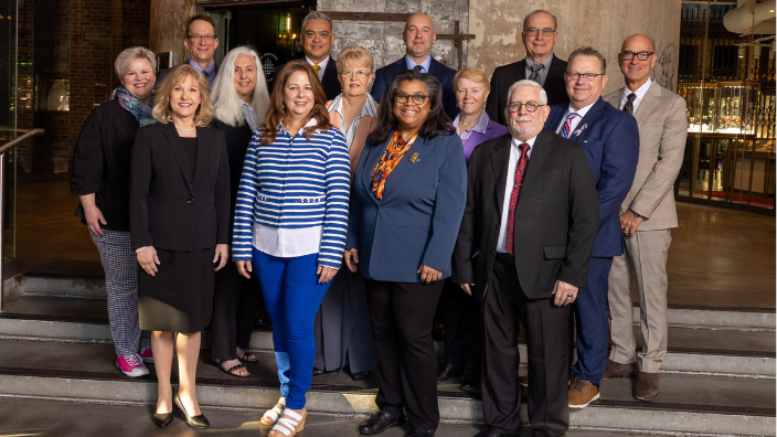 Image of the new, 2025-26 AMTA Board of Directors standing together on a staircase